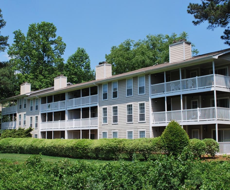 a large building with a green lawn