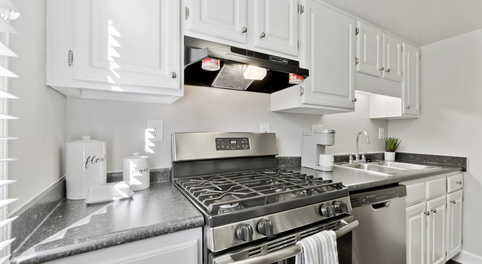 Newly renovated kitchens with stainless steel appliances including gas stovetop and dishwasher