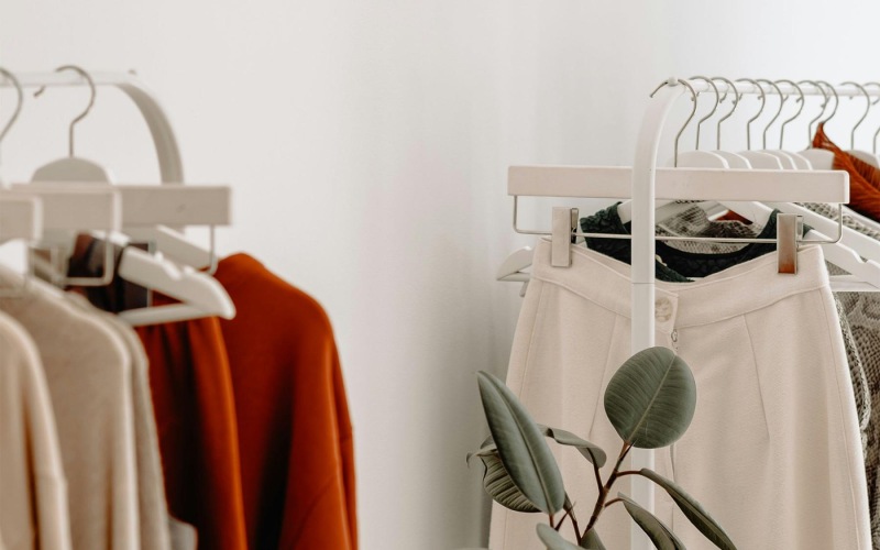 clothes on a rack near a plant