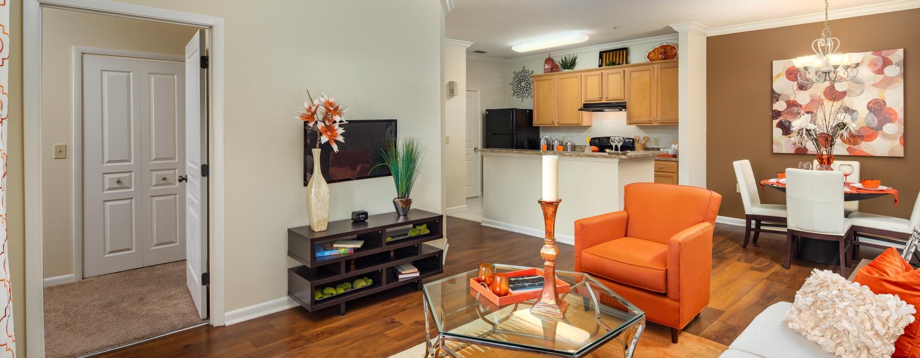 a living room with orange furniture