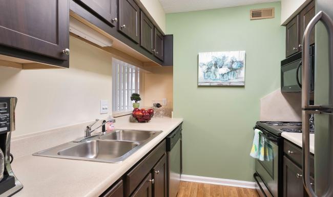 a kitchen with a sink and cabinets