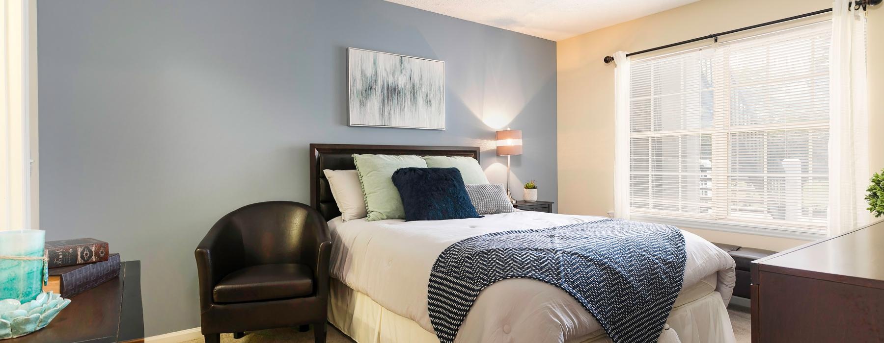 a bedroom with a bed and chair