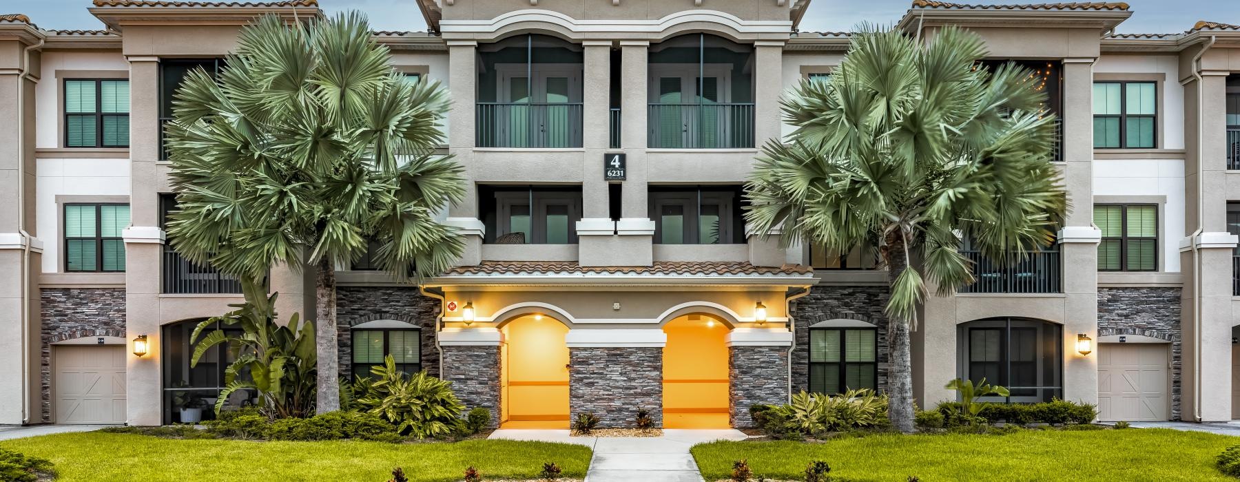 a large white building with palm trees
