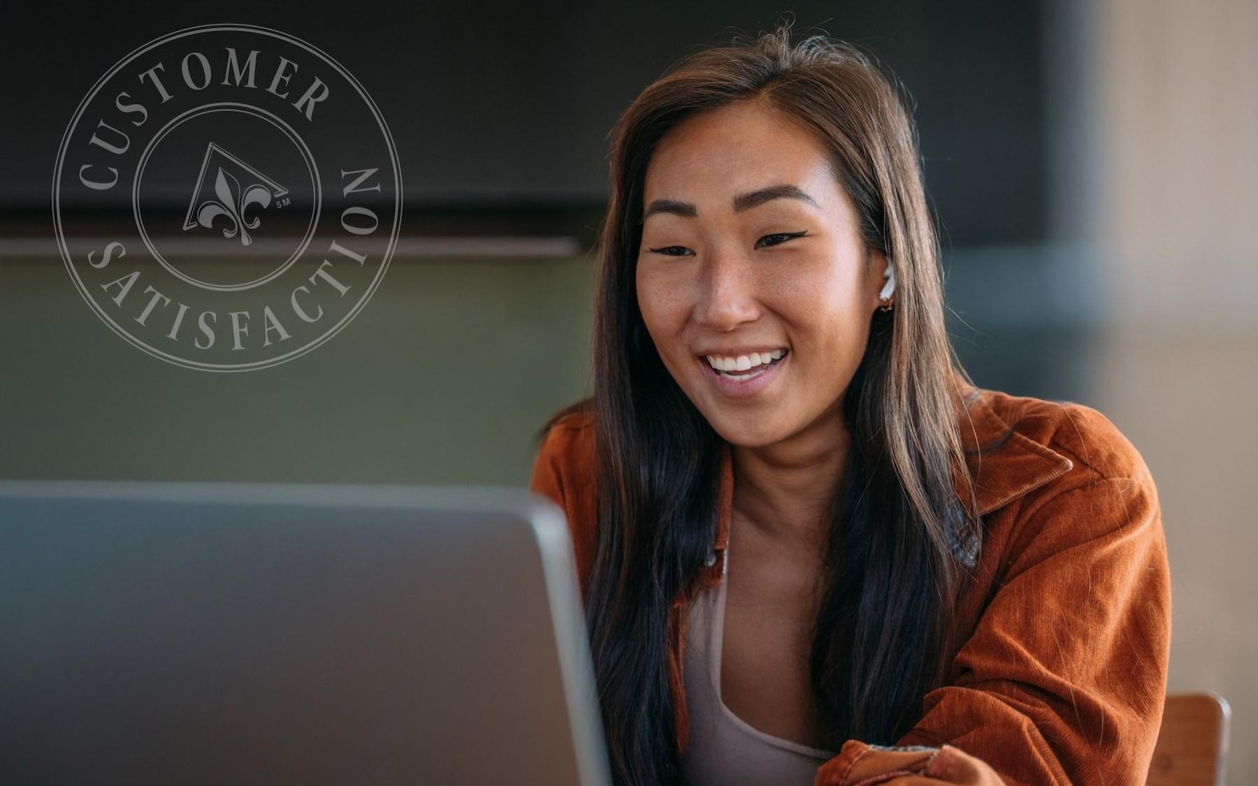 a woman smiling at the computer