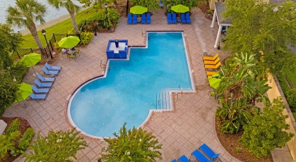 Arial view of resort-style pool surrounded by tropical landscaping