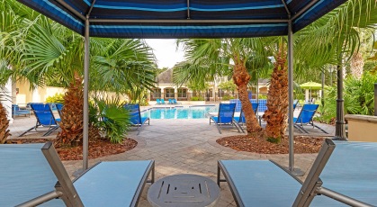 Poolside cabanas surrounded by tropical landscaping