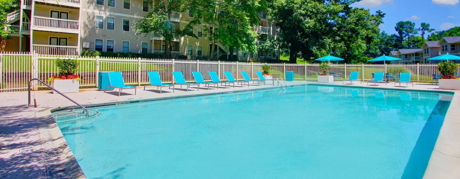 large pool surrounded by adjustable lounge chairs