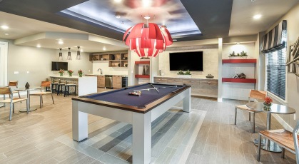 Clubhouse game room with billiards table and kitchen