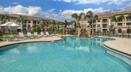 Resort-style swimming pool with waterfall