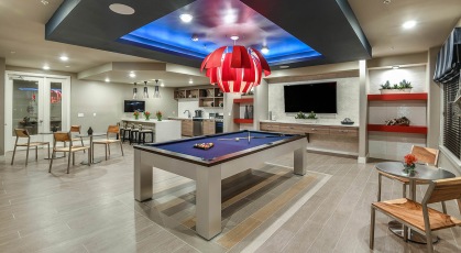 Clubhouse game room with billiards table and kitchen