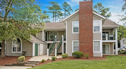 Two-story apartment buildings situated on beautifully landscaped grounds