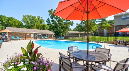 Swimming pool with lounge seating and umbrellas