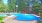 outdoor swimming pool with umbrella shaded tables and chairs