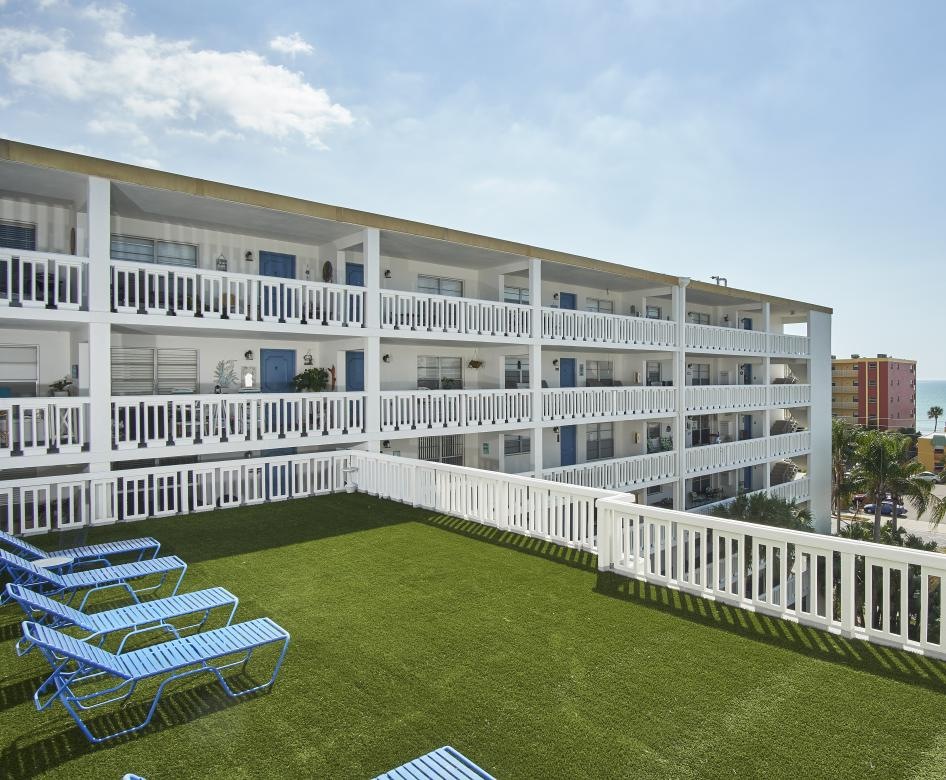 a building with a lawn and chairs