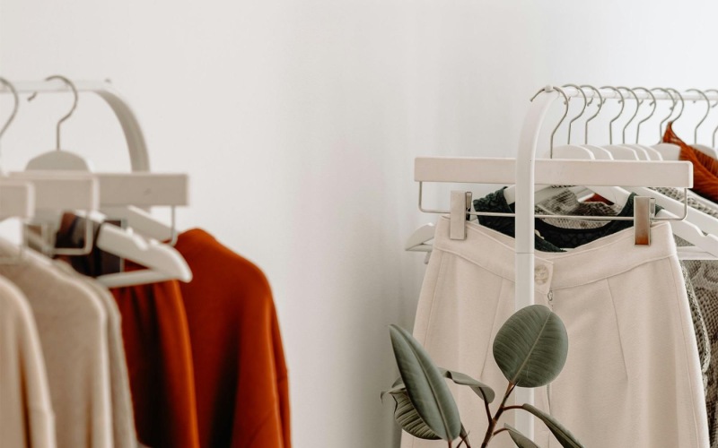 clothes on a rack near a plant