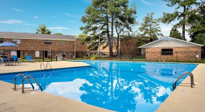 Sparkling swimming pool with lounge seating and umbrellas