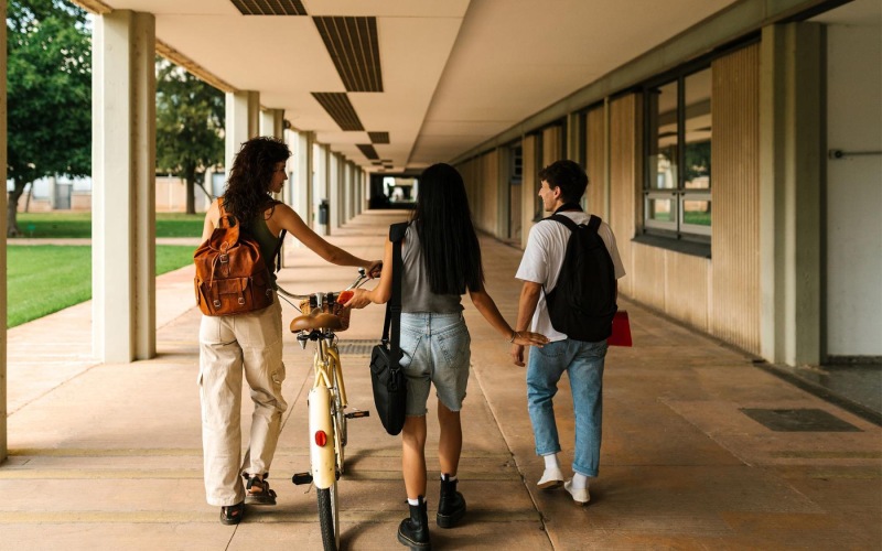 a group of people walking down a sidewalk