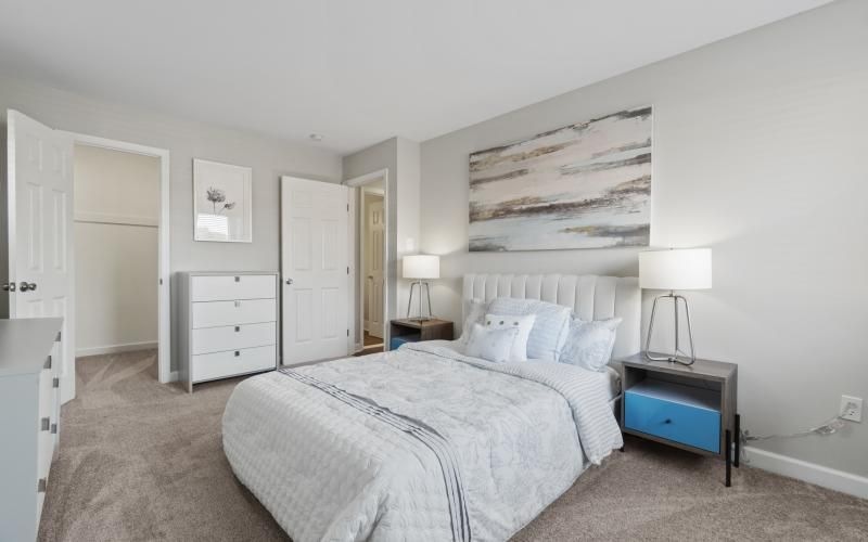 a bedroom with a bed and a lamp