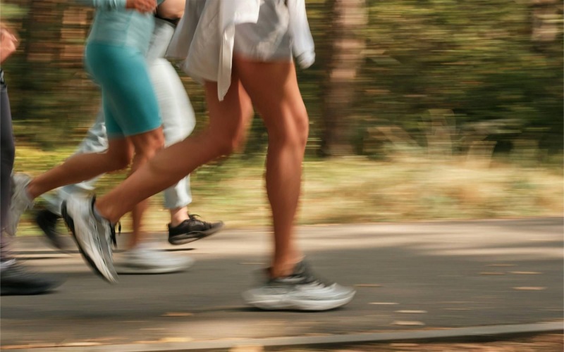 a group of people running on a road
