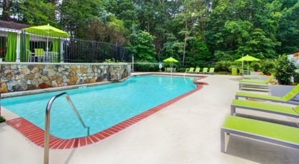 Pool with adjustable lounge chairs and shaded tables