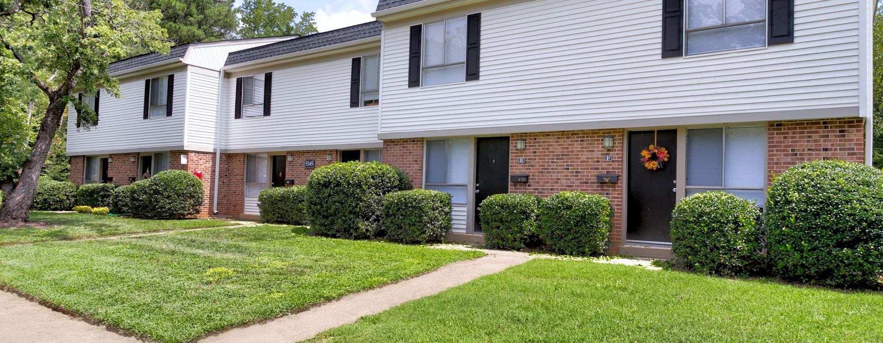 a house with a lawn and trees