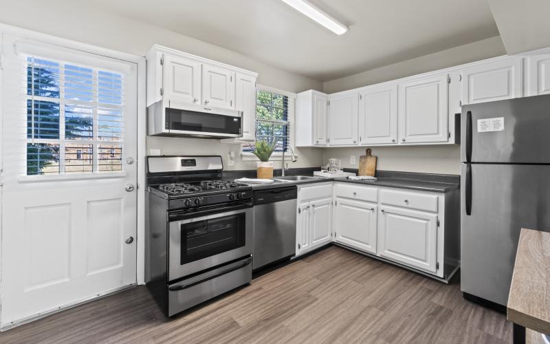 a kitchen with white cabinets