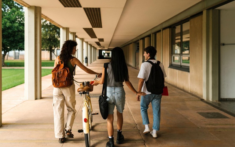 a group of people walking down a sidewalk