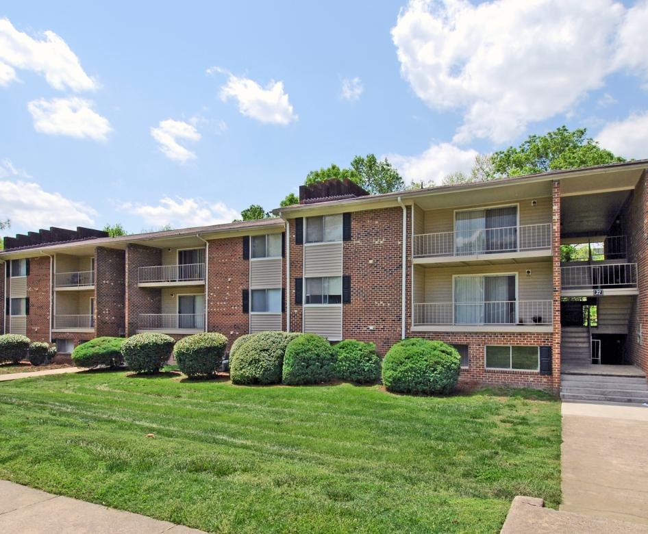 a building with a lawn and trees