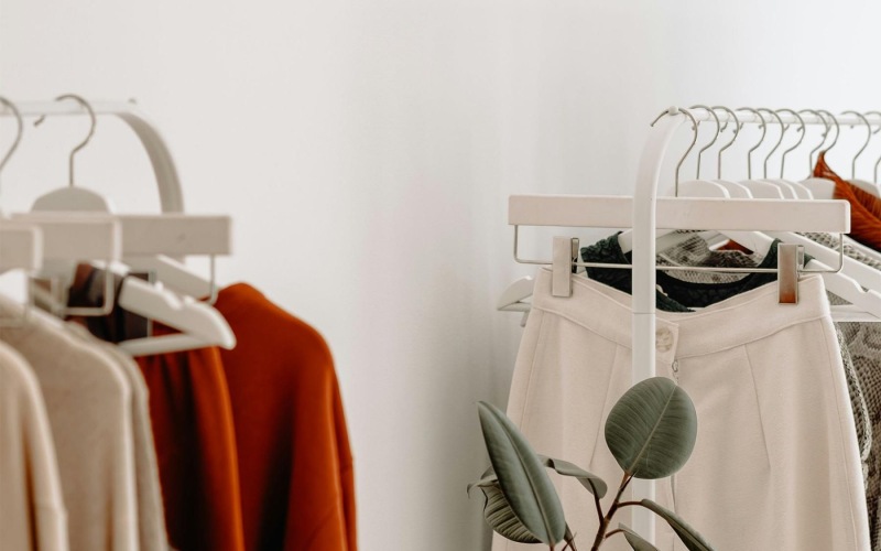 clothes on a rack near a plant