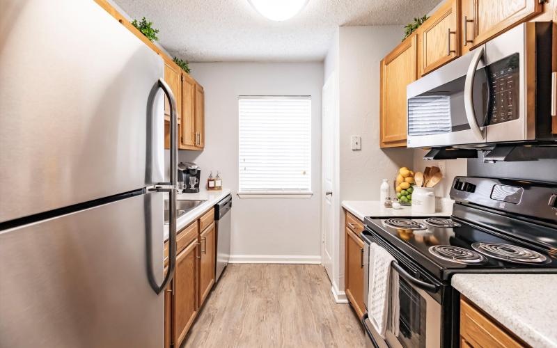 a kitchen with a refrigerator and stove