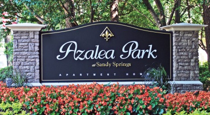 Azalea park signage in a bed of landscaped foliage