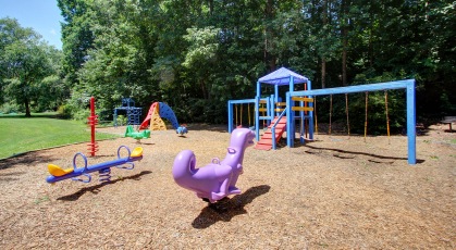 Colorful outdoor playground with wood-chip surface