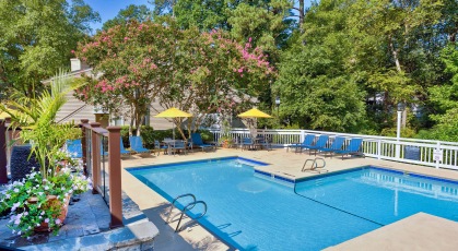 Gated pool area with lounge chairs