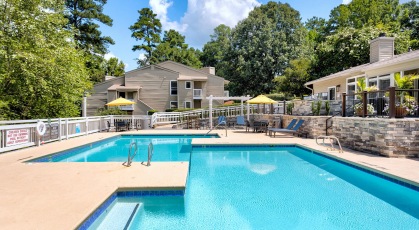 Pool area with lounge chairs and umbrellas