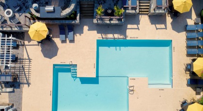 Pool area with lounge chairs and umbrellas