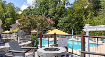 Outdoor firepit and grill area overlooking pool