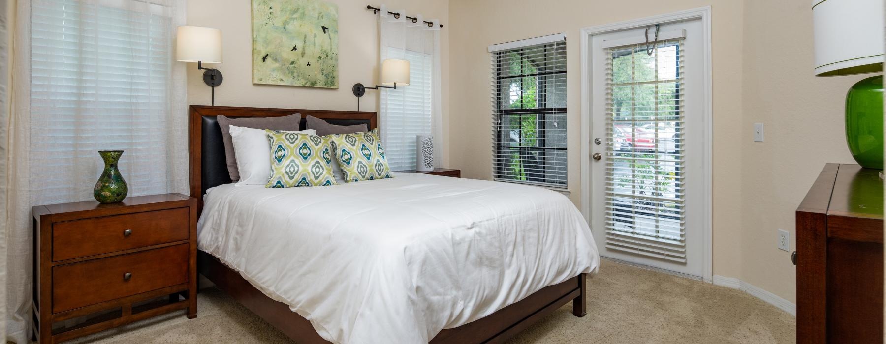 a bedroom with a bed and a lamp