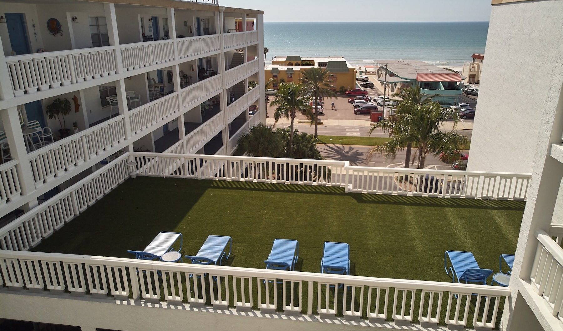a rooftop lounge area in front of a beach