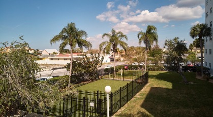 Fenced in dog park on grassy lawn