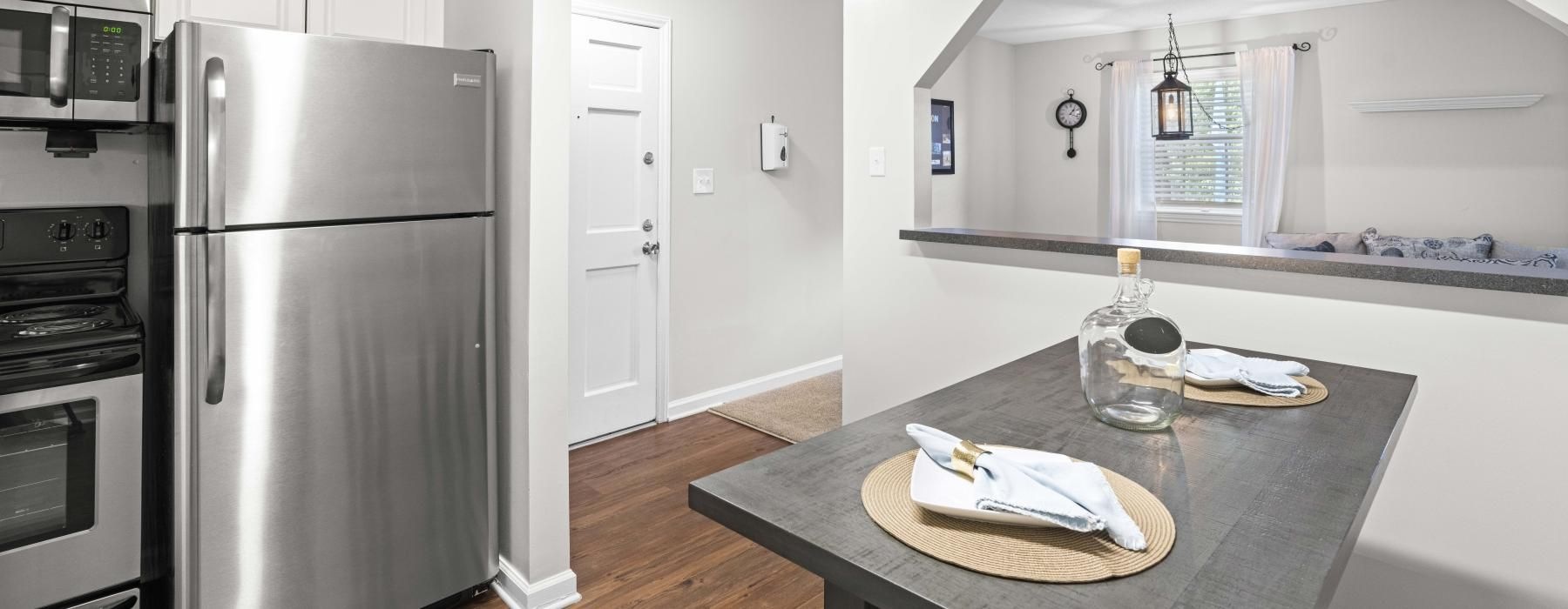 a kitchen with a table and a refrigerator