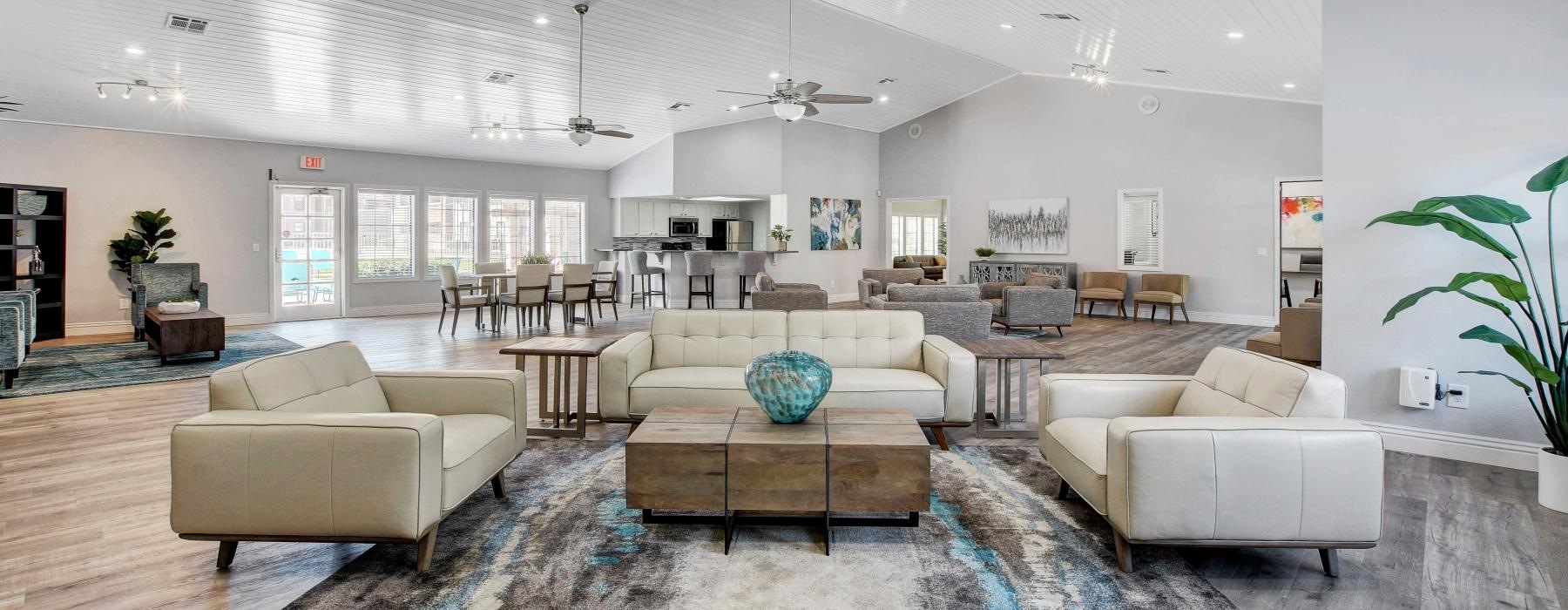 a large club room with a large seating area and a large rug