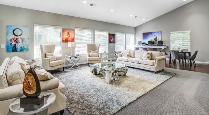 Open concept clubhouse with many windows and plush seating