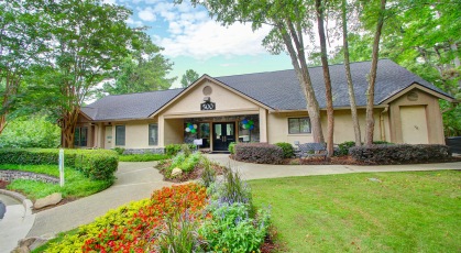 Well landscaped leasing office entrance surrounded by mature trees