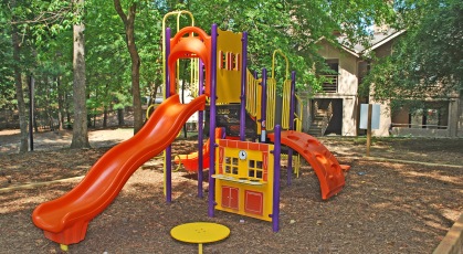 Playground with slides and play equipment on wood chipped surface