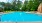 long swimming pool with lounge chairs
