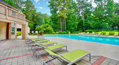Large pool with lounge chairs and umbrellas