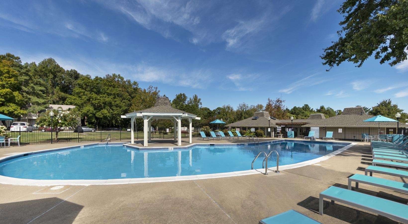 Swimming pool with lounge seating and umbrellas