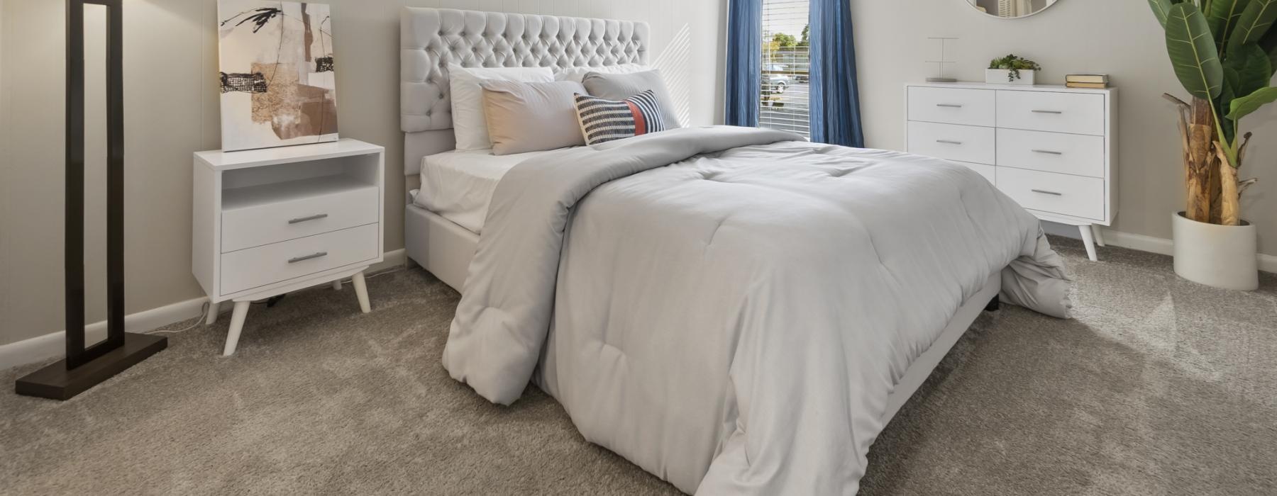 a bedroom with a bed and a plant
