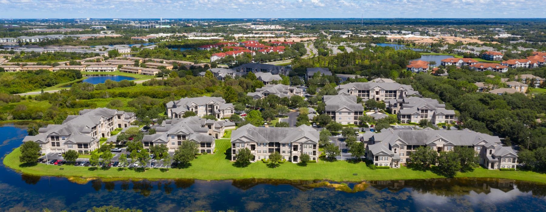 a group of houses next to a body of water