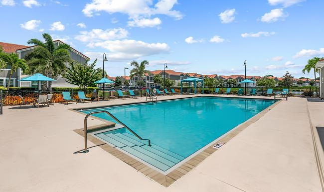 a swimming pool with lounge chairs